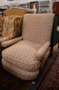 An upholstered Victorian open armchair.