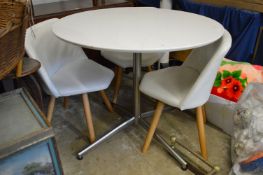 A circular lacquer table with chrome base.