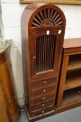 A narrow hardwood storage cupboard.