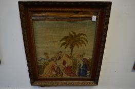 A late Victorian floral embroidered picture of figures under a palm tree.