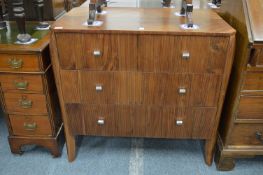 A stylish walnut three drawer chest.