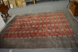 A large Bokhara style carpet, 337cm x 254cm.