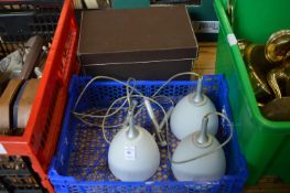 A modern pendant light and a storage box.