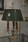 A silver plated three light table lamp with toleware shade.