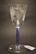 A George III design wine glass with blue and clear air twist stem, the bowl engraved with fruiting