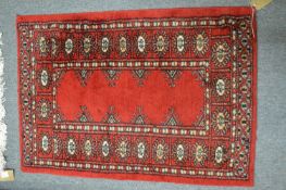 A small Bokhara style rug, 90cm x 63cm.