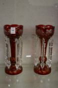A pair of ruby coloured cut glass lustres.