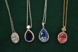 Four decorative pendants and chains.