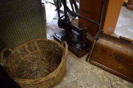 A basket, lloyd loom linen basket and a sewing machine.