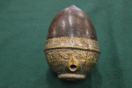 A metal mounted coconut hookah base.