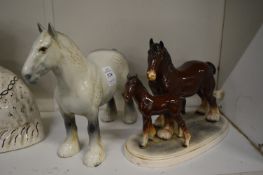 A Beswick shire horse and a porcelain group of two horses.