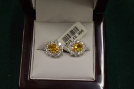 A good pair of 18ct white gold yellow sapphire and diamond cluster ear studs.