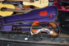 A violin with case and bow, the violin labelled Antonio Stradivarius.