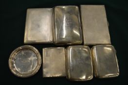 A group of silver cigarette cases and a small dish.