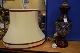 A ruby tinted cut glass table lamp and shade.