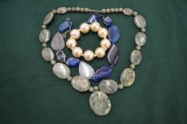 Two chunky bead necklaces and decorative bracelet.