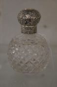 A Victorian cut glass and silver topped scent bottle.