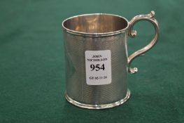 An engine turned silver Christening mug.