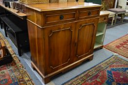 A yew wood side cabinet with two drawers and two cupboard doors.