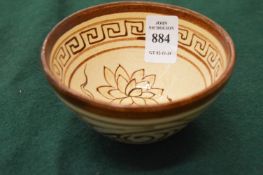 A small Chinese bowl with painted decoration.