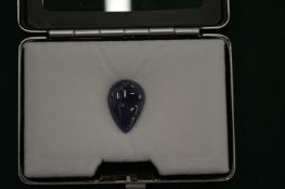 A pear shaped cabochon tanzanite with certificate.