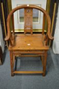 A Chinese horseshoe shaped soft wood armchair.