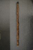 A carved wood walking stick.