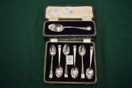 A cased set of six silver coffee spoons and a cased silver dessert spoon.