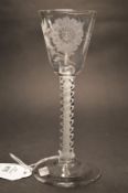 A good George III wine or cordial glass with opaque air twist stem, the bowl engraved with flowers