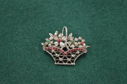 A white metal and gem set basket shaped brooch.