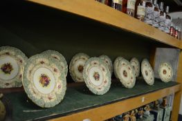 A good set of twelve Royal Worcester cabinet plates painted with flowers.
