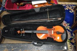 A modern violin with bow and case.