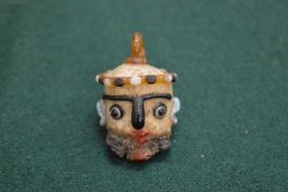 An unusual miniature multi-coloured glass bead or pendant modelled as a head.