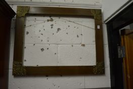 An oak frame with gilt metal corner mounts.