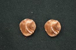 A pair of Cristian Dior ear clips.