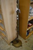 A brass standard lamp.
