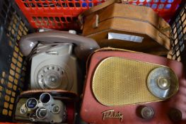 An old radio, telephone and cine cameras.