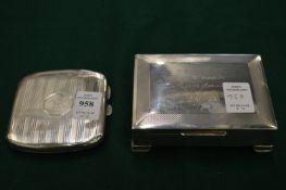 A silver cigarette case and a silver cigarette box.