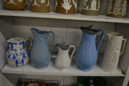 A group of five jugs with moulded decoration.