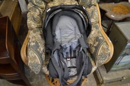 A Graco carrycot/baby seat.