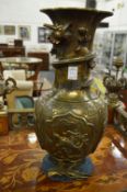 A pair of early 20th century Chinese cast bronze vases, the necks entwined with a dragon.