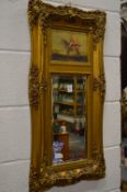 Decorative gilt framed mirror with a panel depicting a huntsman on horseback.