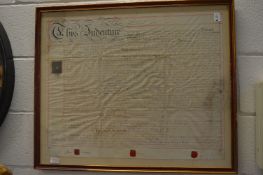 A framed and glazed indenture.