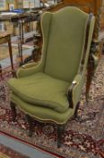 An unusual mahogany framed small wing armchair with three legs to the front.