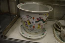 Chinese famille rose decorated jardiniere and stand (rim chipped).