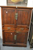A Chinese redwood four door, two drawer cabinet with fitted interior.