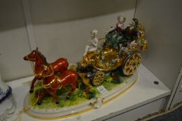Colourful porcelain group of a coach and horses.