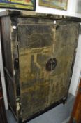 A Chinese wardrobe with distressed paint work.