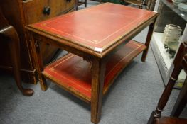 A leather top mahogany two-tier coffee table.
