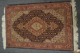 A good small Persian rug, 92cm x 60cm.